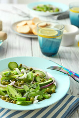 Plate with fresh vegetable salad on table
