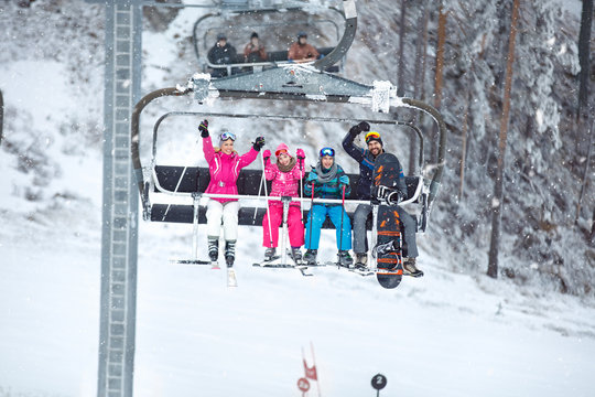 Parents with children in the ski chair  lifting up the ski terrain