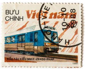 Old postage stamp with blue electric locomotive and railway, printed in Vietnam in 1988