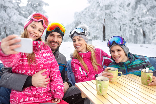 Girl making selfie together with smiling family