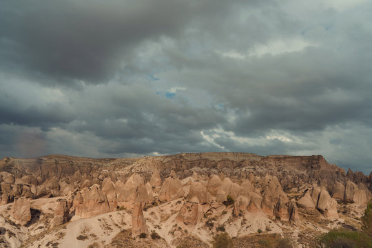 rocky landscape in cloudy weather, rain and sun in canyon