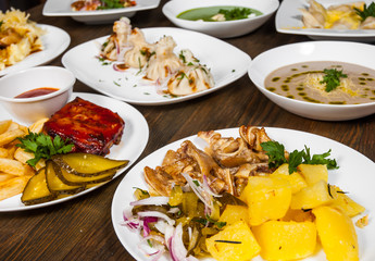 dishes with different food on the wooden table.