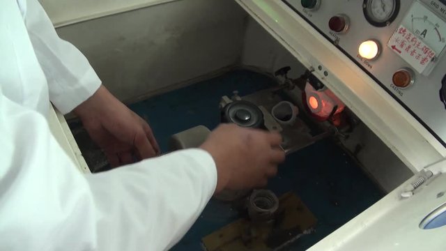 An operator is preparing the centrifugal induction casting machine in a dental laboratory. Dental lab equipment.
