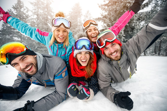 Group of skiers enjoying together on snow in mountain
