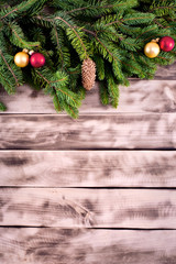 Fototapeta na wymiar Christmas fir tree on natural wooden background.