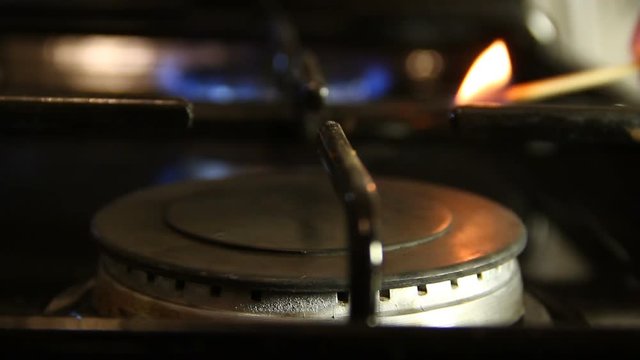 Ignition gas stove with a match closeup
