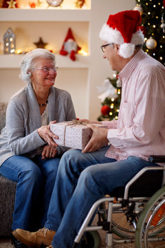 elderly couple sharing Christmas gifts.