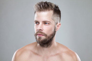 Fototapeta premium Portrait of young bearded man with a new hair cut