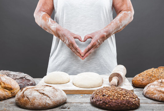 Baker preparing delicious fresh bread and pastry