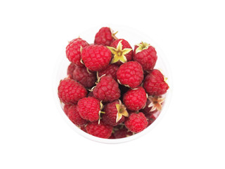 Ripe garden raspberries on stems in a clear plastic cup isolated on a white background. Rubus...