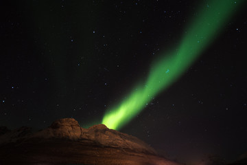Fototapeta na wymiar Aurora borealis over lyngen alps & Ersfjord