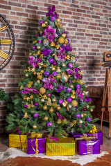 Fototapeta na wymiar Classic green tree decorated in christmas toys. Merry christmas and new year interior background with brick wall