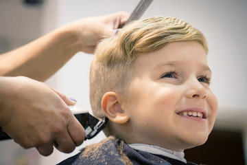 Cute kid at hairdresser's.