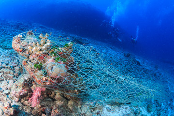 An abandoned fishing net (Ghost net) stuck on a tropical coral reef