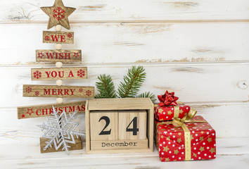 Christmas Gifts ,Pine Tree and Wooden Calendar with Date on White Wooden Background. Christmas Concept
