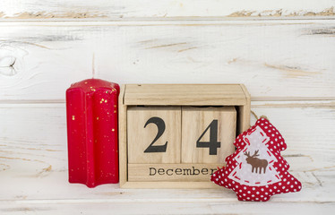 Christmas Gifts and Wooden Calendar with Date on White Wooden Background. Christmas Concept