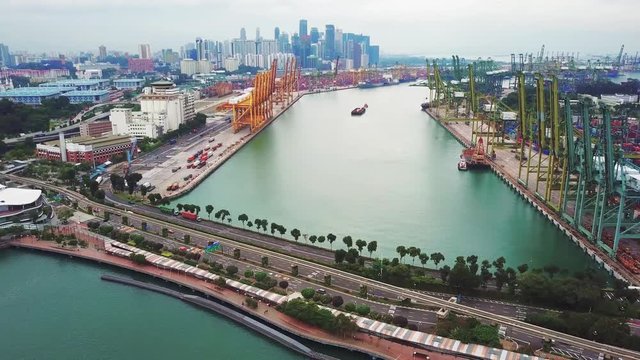 Singapore. November 21, 2017: Aerial view of Singapore port with city skyline and row of crane. Shot in 4k resolution
