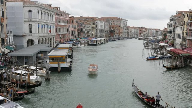VENICE, ITALY, SEPTEMBER 7, 2017: houses built with stunning Venetian architecture, standing on a canal, along which gondolas and tourist boats walk