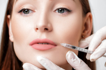 woman getting injection on lips. 