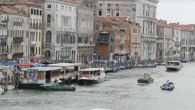 VENICE, ITALY, SEPTEMBER 7, 2017: houses built with stunning Venetian architecture, standing on a canal, along which gondolas and tourist boats walk