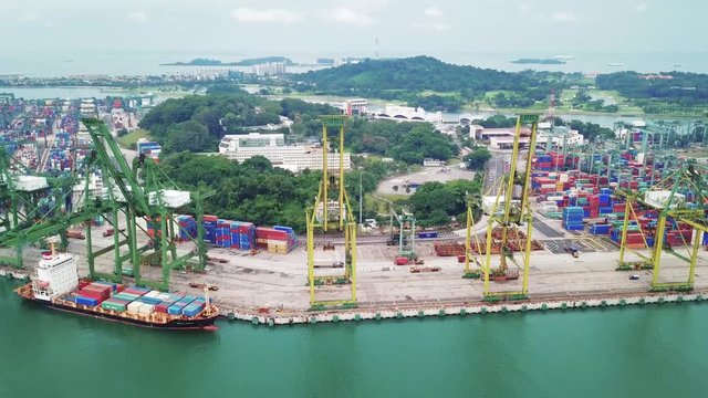 Singapore. November 21, 2017: Aerial footage of crane and container ship in Singapore port. Shot in 4k resolution