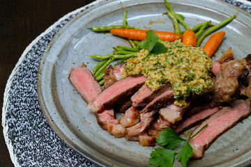 Close up Steak with Green Olive Pesto. (selective focus)