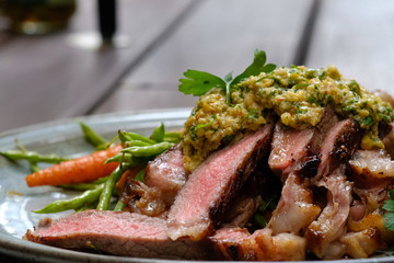 Close up Steak with Green Olive Pesto. (selective focus)