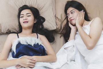 snoring woman, Asian Girls can not sleep, covering ears with Hands for snore noise, sleeping in...