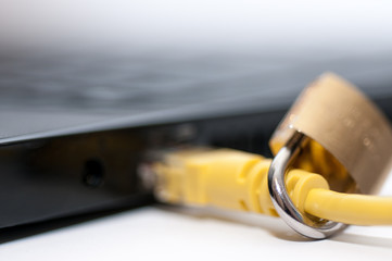 Yellow internet cable, padlock , conceptual network, internet security image close up shot.