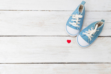 Children's sneakers for a boy of blue color and a red heart. Mockup