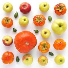Autumn concept. Pumpkin, persimmon, red and green apples on a white background. Pattern of fresh vegetables. Top view, flat lay. A composition of fresh vegetables and fruits in a square format.