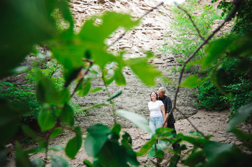 Naklejka na ściany i meble Active loving senior couple walking in beautiful summer forest - active retirement concept