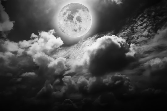 Dramatic atmosphere panorama of full moon and clouds on beautiful night sky background in Black and White.Element of Full moon image furnished by NASA.