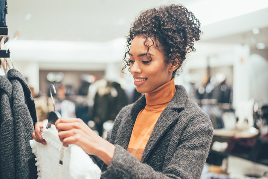 Black young woman doing shopping in a store