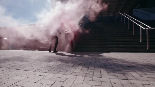 Free runners doing parkour with smoke grenades