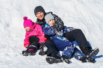 Fototapeta na wymiar Father with children on winter walk.