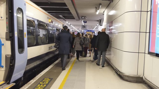 Railroad station. People go on the platform.