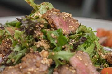 Close up Roasted beef with herbed bread crust sliced and vegetable. (selective focus)