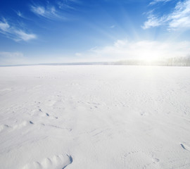 Fototapeta na wymiar Snowcovered fields on blue sky