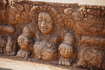 Sri Lanka, Anuradhapura. Mythological character on stone wall of temple