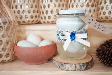 Salty eggs. Salted eggs in a glass jar, with blue ribbon and lace DIY gift wrapping. Ideas for New Year present using eggs