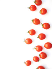 Pattern of cherry tomatoes isolated on white background. Vertical composition of tomatoes. Food background, wallpaper, screensaver. Top view, flat design.