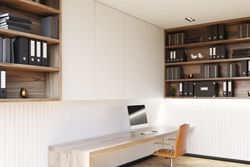 White home office corner with a wooden floor, a desk, a computer, bookshelver and an orange chair. 3d rendering mock up