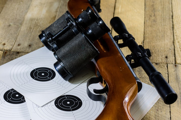 shooting, pneumatic and firearms on a wooden table. Table on the shooting range, weapons and...