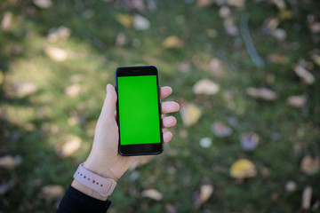 Mobile device technology watch tablet phone green screen hand