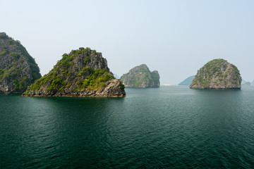 Fototapeta na wymiar Small rocky islands in Halong Bay, Vietnam