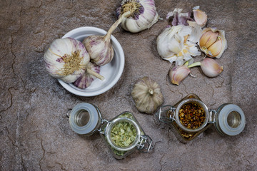 garlic and spices on a stone table in the kitchen. Healthy and fragrant cloves of garlic. Stone table.