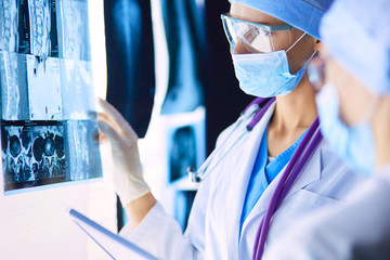 Two female women medical doctors looking at x-rays in a hospital