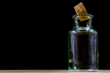 Empty bottles of milk on a wooden kitchen table. Bottle with a stopper.
