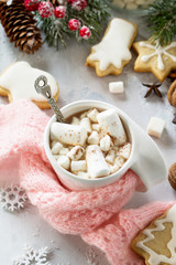 Christmas background frame or greeting xmas card. Christmas table decor and a cup of hot chocolate with a warm scarf.